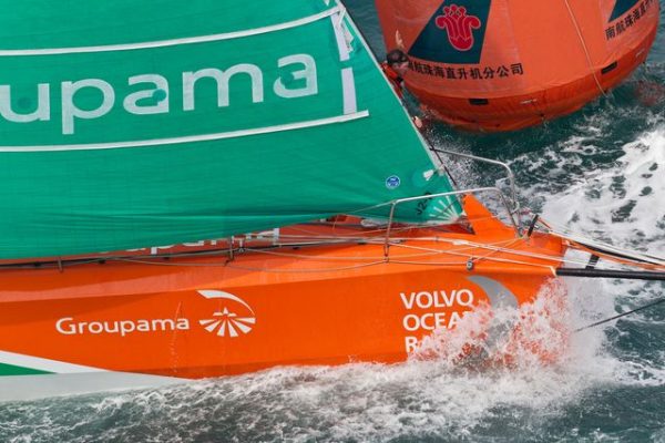 Bowman Brad Marsh signals to his crew onboard Groupama Sailing Team, skippered by Franck Cammas from France, as they round a mark in the Sanya Haitang Bay In-Port Race, during the Volvo Ocean Race 2011-12. (Credit: IAN ROMAN/Volvo Ocean Race)